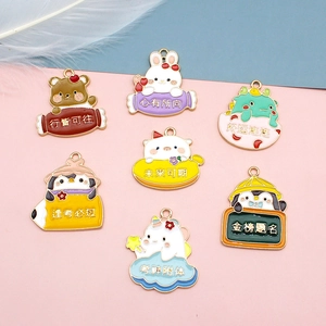 Detail shot of cute cartoon animal enamel charms featuring lucky Chinese blessing text