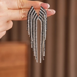 Detailed close-up of vintage rhinestone tassel earrings with black and white crystals