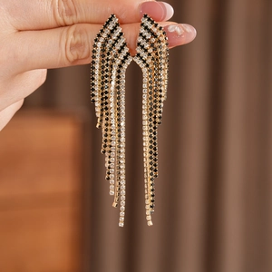 Close-up detail of vintage long tassel earrings featuring black and white rhinestones