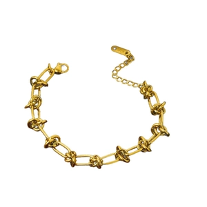 Retro golden knot chain necklace with lobster clasp and adjustable extension on white background