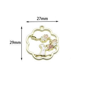 Detailed view of gold-tone cherry blossom and cat enamel charm with 27mm x 29mm dimensions