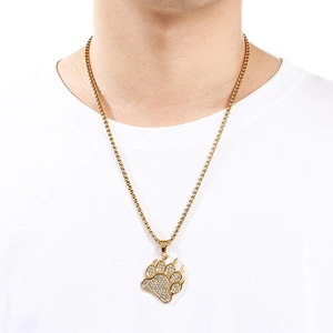 Detail of a gold hip hop necklace featuring a fully iced-out bear paw pendant with zircons