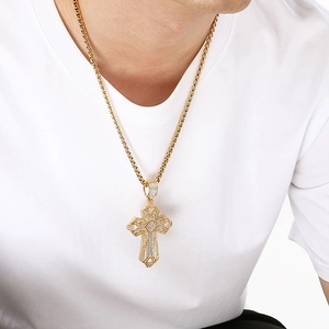 Close-up of a men's iced-out gold cross pendant with intricate geometric diamond settings