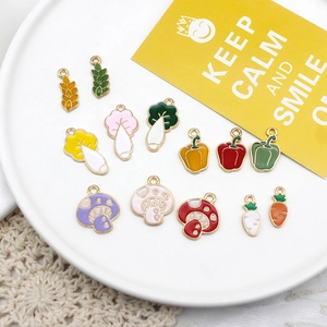 Detailed view of colorful enamel vegetable and grain charms for creative DIY jewelry crafts
