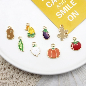 Detailed macro view of colorful enamel vegetable and fruit charms for DIY jewelry crafting