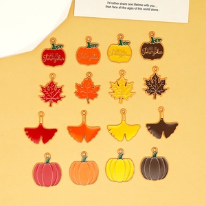 Collection of autumn themed enamel charms featuring maple leaves, ginkgo leaves and pumpkins.