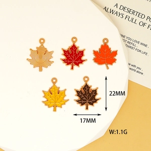 Close-up detail view showing 22mm x 17mm size of colorful maple leaf enamel charms
