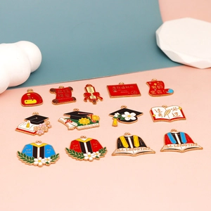Detailed macro view of colorful graduation themed alloy charms for DIY crafting.