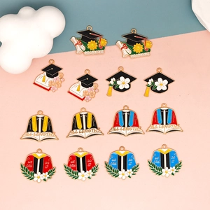 Detailed macro view of graduation-themed alloy enamel charms for DIY jewelry making