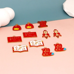 Macro view of red and white enamel student exam success charms for DIY jewelry