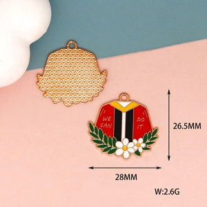 Macro detail view of graduation gown charm showing 28mm x 26.5mm size and weight
