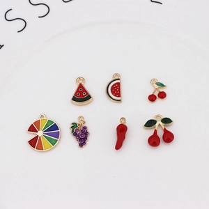 Detailed view of colorful enamel fruit charms including watermelon and cherry for DIY jewelry