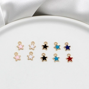 Detailed macro view of colorful mini star charms in gold alloy for DIY jewelry making