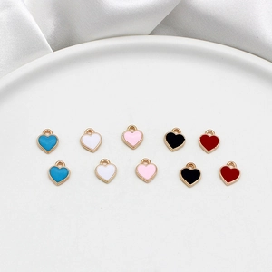 Detailed view of colorful alloy heart charms with gold-tone edges for DIY jewelry