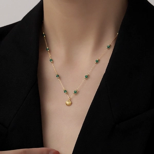 Elegant gold titanium steel necklace with green beads and a delicate shell pendant