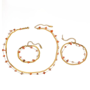 Detailed display of double-layer stainless steel jewelry set featuring elegant red stone beads.