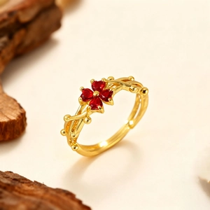 Adjustable 18k gold plated vine ring featuring a red four-leaf clover heart design