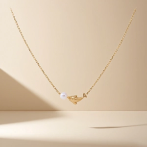 Golden dolphin and pearl necklace for women featuring a minimalist thin steel chain link