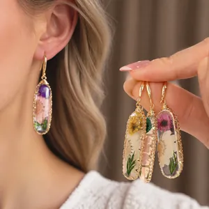 Elegant handcrafted resin oval drop earrings featuring real dried flowers in sweet style