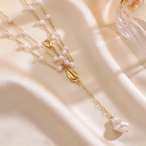 Exquisite layered gold body chain featuring pink pearls and a baroque pearl shell pendant