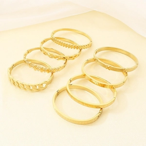 Elegant set of vintage gold-plated titanium steel bangles with various geometric textures