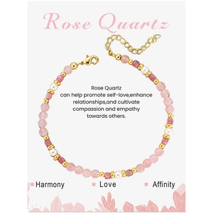 Detail of Rose Quartz beaded bracelet with white pearls and gold charms on a display card