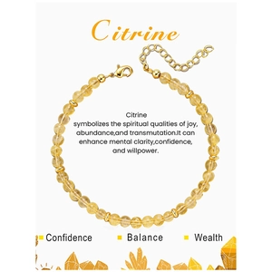 Detailed view of 4mm citrine beaded bracelet with gold heart charm on display card