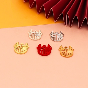 Detailed view of alloy Fu charms in various metallic colors for New Year DIY jewelry.