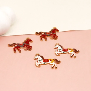Detailed macro view of red and white enamel horse charms featuring gold-tone alloy edges