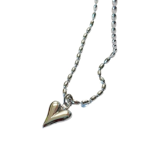 Polished silver heart pendant necklace featuring modern oval metal beaded chain design