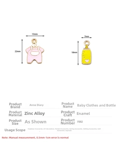 Close-up of enamel baby clothes and bottle charms with dimension details in 80 characters.