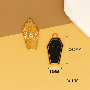 Close-up detail of gothic coffin charms showing size and weight for DIY jewelry