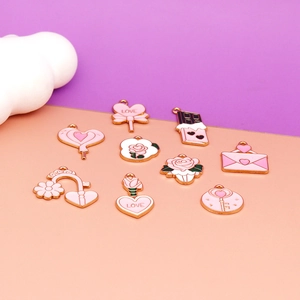 Close-up of mixed Valentine's Day pink enamel heart and rose alloy charms.