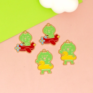 Detailed view of cute green cat enamel charms with airplane and duck floatie designs