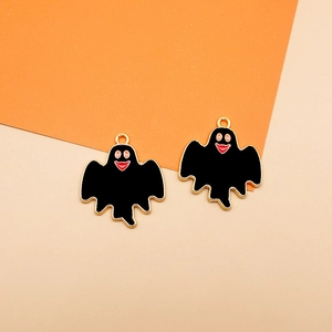 Detailed view of two black enamel ghost pendants for Halloween DIY jewelry making