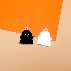 Detail view of black and white ghost alloy charms for Halloween DIY jewelry making.
