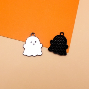 Detailed view of cute white and black ghost alloy charms for Halloween DIY jewelry