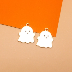 Macro view of cute white enamel ghost charms with gold plated edges for Halloween jewelry
