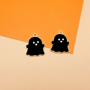 Macro view of cute black enamel ghost charms with gold-plated edges for Halloween DIY