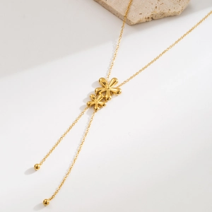 Elegant gold titanium steel Y-necklace featuring double layered flower pendants on stone