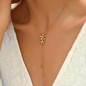 Elegant gold titanium Y-shaped tassel necklace featuring delicate double flower pendants