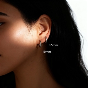 Detailed view of silver hoop earrings in 8.5mm and 10mm sizes shown on a model