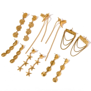 Close-up of elegant gold stainless steel earrings featuring sea shell and starfish designs