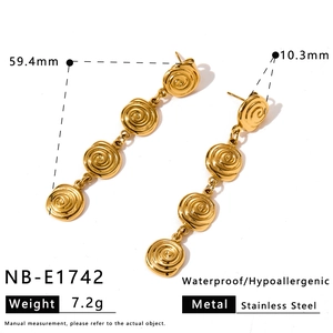 Detailed view of gold stainless steel long dangling earrings with spiral design.