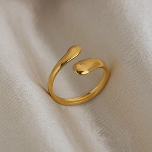 Minimalist 18K gold plated stainless steel teardrop open ring on elegant silk background
