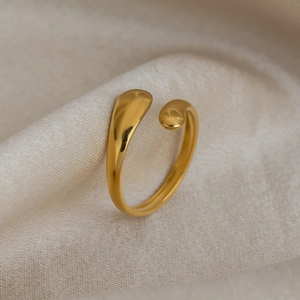 Macro view of adjustable gold-plated stainless steel teardrop open ring on silk
