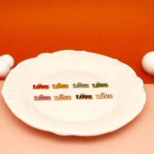 Detailed macro view of colorful alloy drip oil LOVE charms for DIY jewelry making