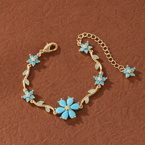 Detail of flower bracelet with turquoise petals and adjustable gold lobster clasp