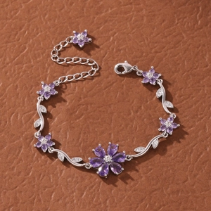 Elegant silver flower bracelet with purple gemstones and cubic zirconia leaf details