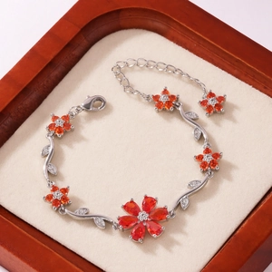 Elegant silver bracelet with orange zircon flower petals and micro-paved leaf links